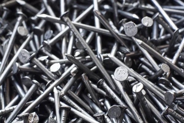 Macro photo of metal nails top view. Industrial building background made of steel nails close-up.