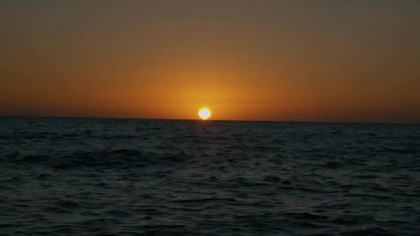 Sol hundiéndose en el horizonte en el mar — Vídeo de stock