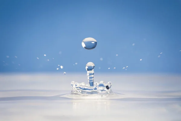 Water splash on a blue background — Stock Photo, Image