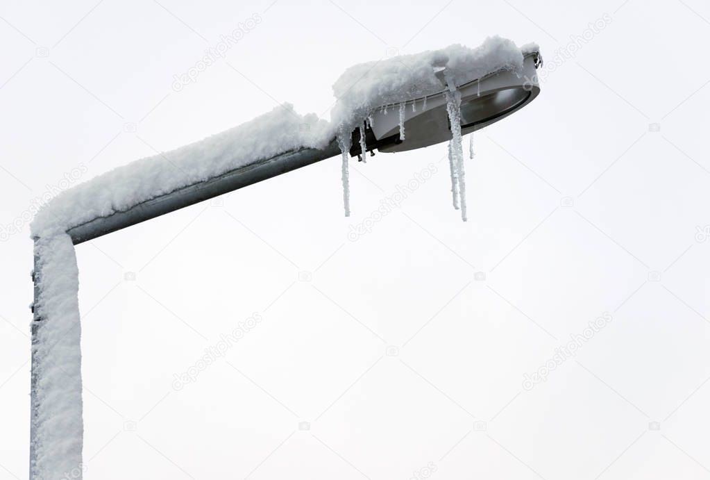 Street lamp with snow and stalactites