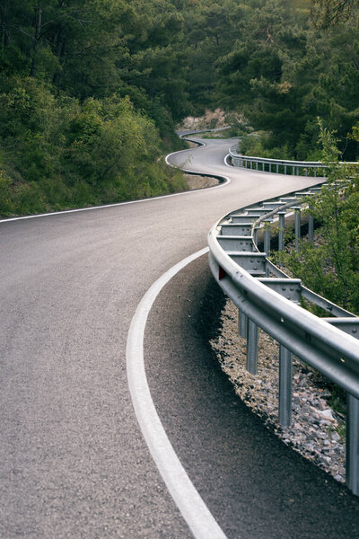 S shaped road in forest.