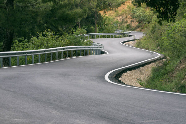 S shaped road in forest.