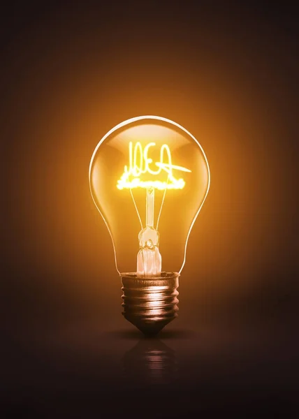 IDEA escreveu bulbo ativo em um fundo escuro . — Fotografia de Stock