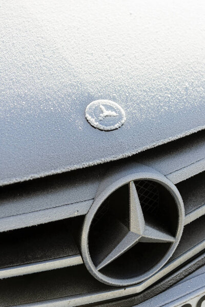 Black colored Mercedes brand Covered with snow.