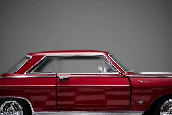 Side view of a red colored 1960 Chevrolet Nova toy model car. — 스톡 사진