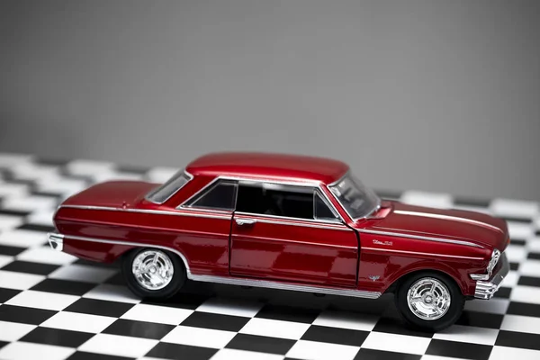 Side view of a red colored 1960 Chevrolet Nova toy model car. — 스톡 사진