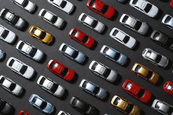Parked toy cars on a black background like a car parking lot. — ストック写真