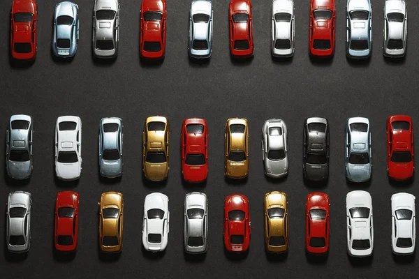 Parked toy cars on a black background like a car parking lot. — ストック写真