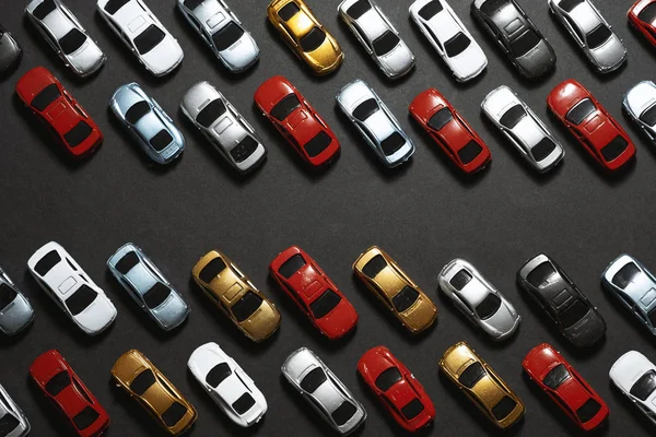 Parked toy cars on a black background like a car parking lot. — ストック写真