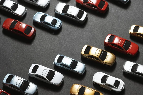 Parked toy cars on a black background like a car parking lot. — ストック写真