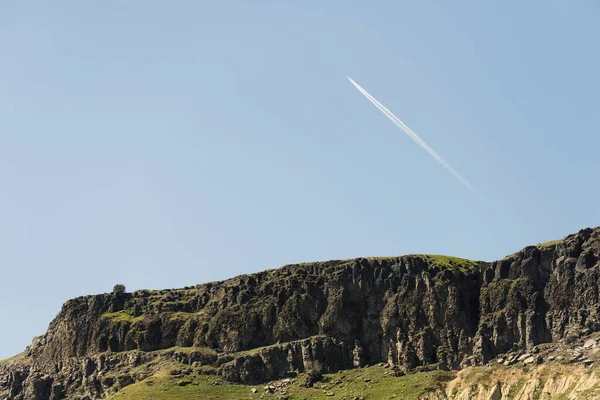 Rocky hills with a jet plane. — Stock Photo, Image