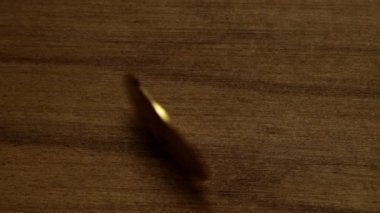 Top view of a Turning bitcoin which gets shine after stops.