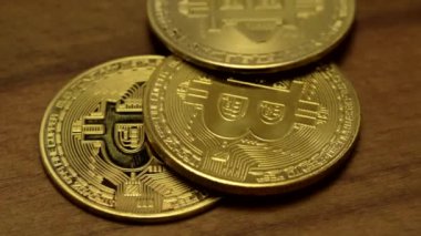 Roughly counting Bitcoins on a wooden table.