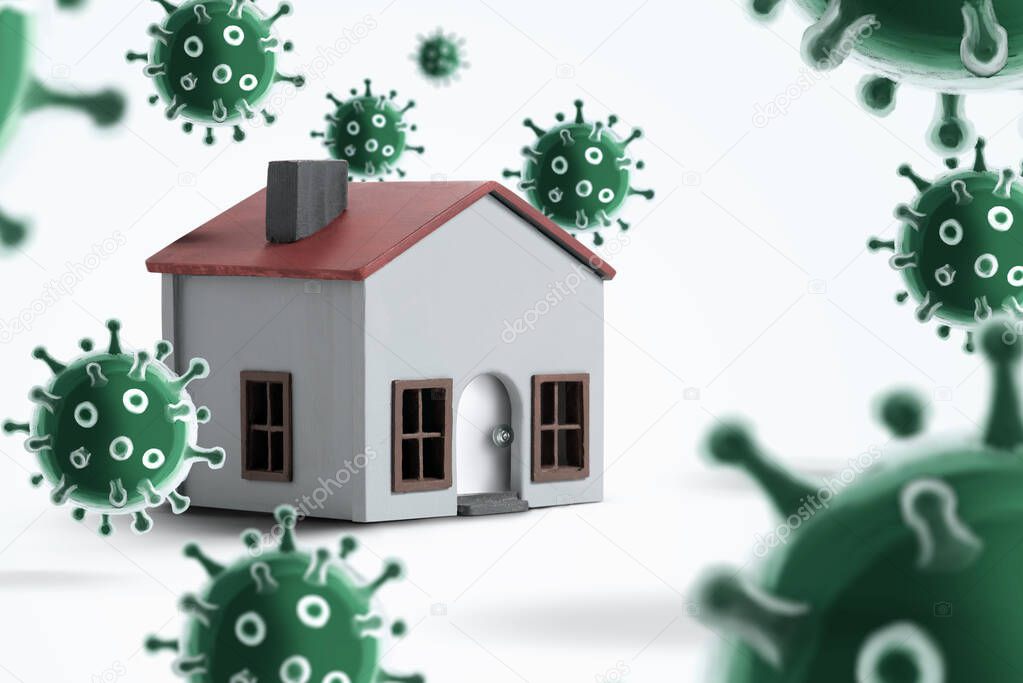 Model house on a white background with viruses around. It gives the message stay at home and work at home.