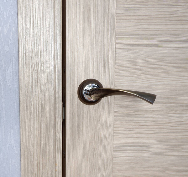 Stylish door handle in the room. Interior design.