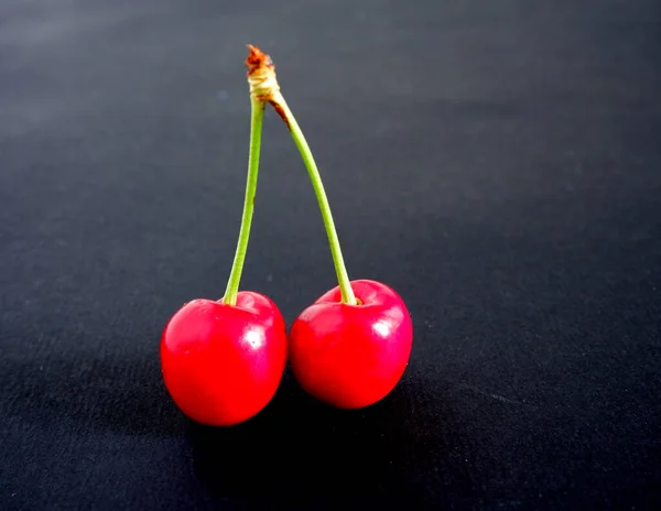 Cherry on a black background. Vitamins. Fruit