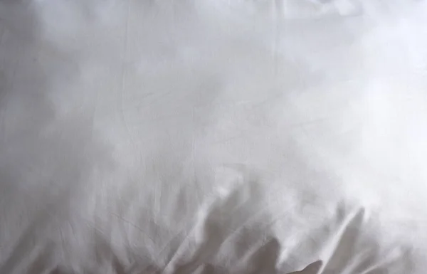 Texture of white bed linen. Suitable for advertising background.