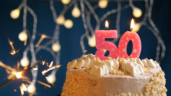 Birthday cake with 50 number pink candles and burning sparkler on blue backgraund. Close-up — Stock Photo, Image
