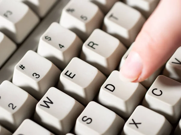 Female forefinger pushes D button. Close-up — Stock Photo, Image