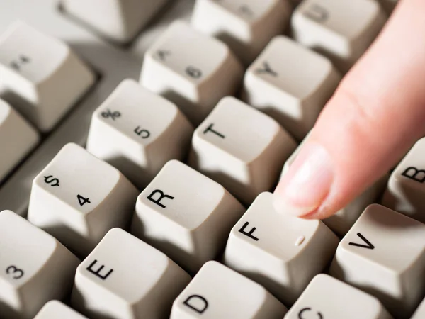 Female forefinger pushes F button. Close-up — Stock Photo, Image