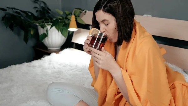 女の子は紅茶を飲んでいる 魅力的な若い女性は病気であり ベッドに座っている間にレモンとお茶を飲む インフルエンザ 喉の痛み 急性呼吸器疾患の概念 — ストック写真