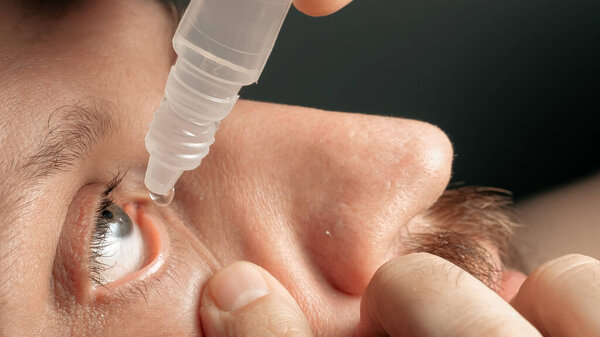 Tired middle-aged man dripping eye drops. Glaucoma, cataracts, eye diseases, keratoconjunctivitis, allergies, inflammation conjunctivitis fatigue alcoholism addiction concepts