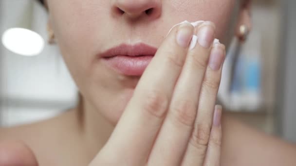 Shaving female mustache concept. Young attractive woman is applying shaving foam to her face in mustache growth area, preparing to shave her hair. Close-up — Stock Video