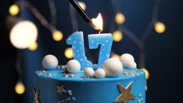 Birthday cake number 17 stars sky and moon concept, blue candle is fire by lighter and then blows out. Copy space on right side of screen if required. Close-up and slow motion — Stock Video