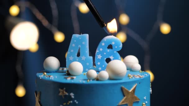 Birthday cake number 46 stars sky and moon concept, blue candle is fire by lighter and then blows out. Copy space on right side of screen if required. Close-up and slow motion — Stock Video