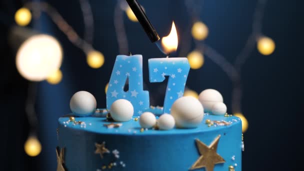 Birthday cake number 47 stars sky and moon concept, blue candle is fire by lighter and then blows out. Copy space on right side of screen if required. Close-up and slow motion — Stock Video