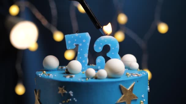 Birthday cake number 73 stars sky and moon concept, blue candle is fire by lighter and then blows out. Copy space on right side of screen if required. Close-up and slow motion — Stock Video