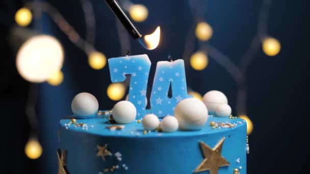 Birthday cake number 74 stars sky and moon concept, blue candle is fire by lighter and then blows out. Copy space on right side of screen if required. Close-up and slow motion — Stock Video