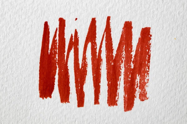 Red color spots and lines of paint on paper