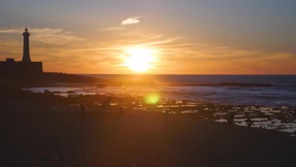 Coucher de soleil à rabat le long de la mer Méditerranée avec un phare en arrière-plan