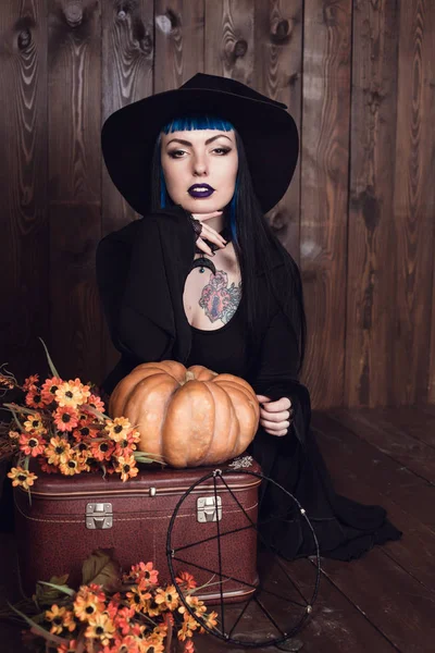 Woman sitting with lantern pumpkin — Stock Photo, Image