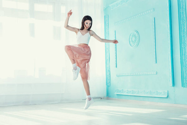 girl posing on turquoise background