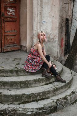 merdivenlerde oturan sarışın kız