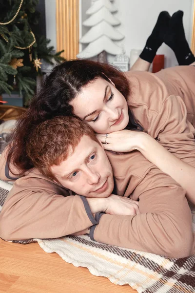 Par liggande nära julgran — Stockfoto