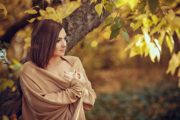 Attractive woman posing in yellow autumn park