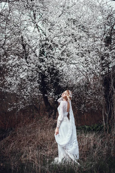 Blonde vrouw in lange witte jurk — Stockfoto