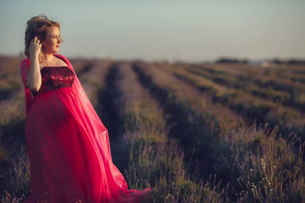 Těhotná žena v poli levandule — Stock fotografie