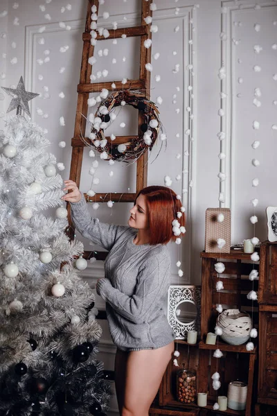 Kobieta stojąc w pobliżu choinki — Zdjęcie stockowe