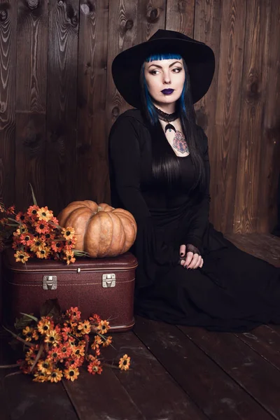 Woman sitting with lantern pumpkin — Stock Photo, Image