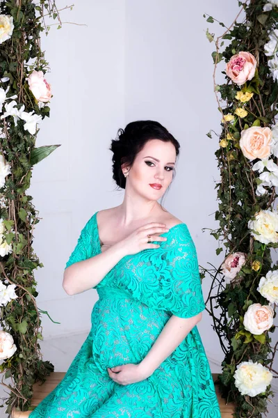 Pregnant woman in mint dress — Stock Photo, Image