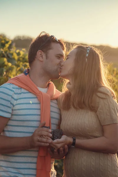 Беременная женщина с мужем целуется на открытом воздухе — стоковое фото