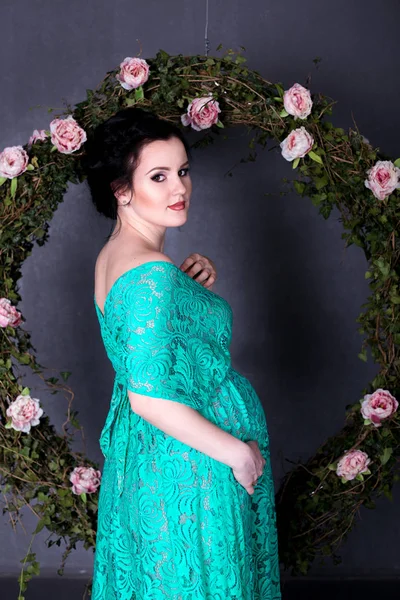 Pregnant woman in mint dress — Stock Photo, Image