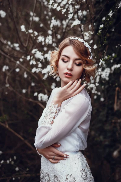 Blonde woman in blooming garden — Fotografie, imagine de stoc