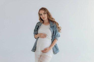 Young beautiful pregnant woman at home summer