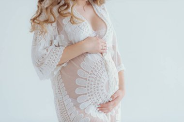 Young beautiful pregnant woman at home summer