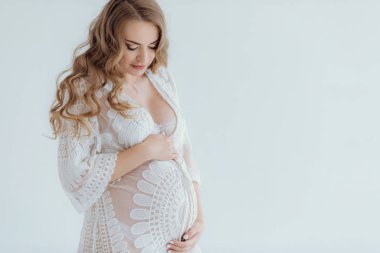 Young beautiful pregnant woman at home summer